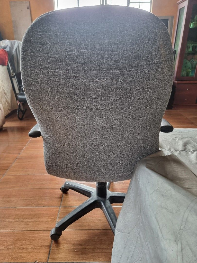 Grey Fabric Office Chair with Armrests (Category: Office Furniture & Fixtures) located in Quezon City. Submitted by rl_minimalist (Listing ID 1464615649, Image 3). Description: - Grey fabric office chair - Comfortable armrests - Swivels and rolls easily - Ideal for home or office - Minor fabric wear, fully functional.