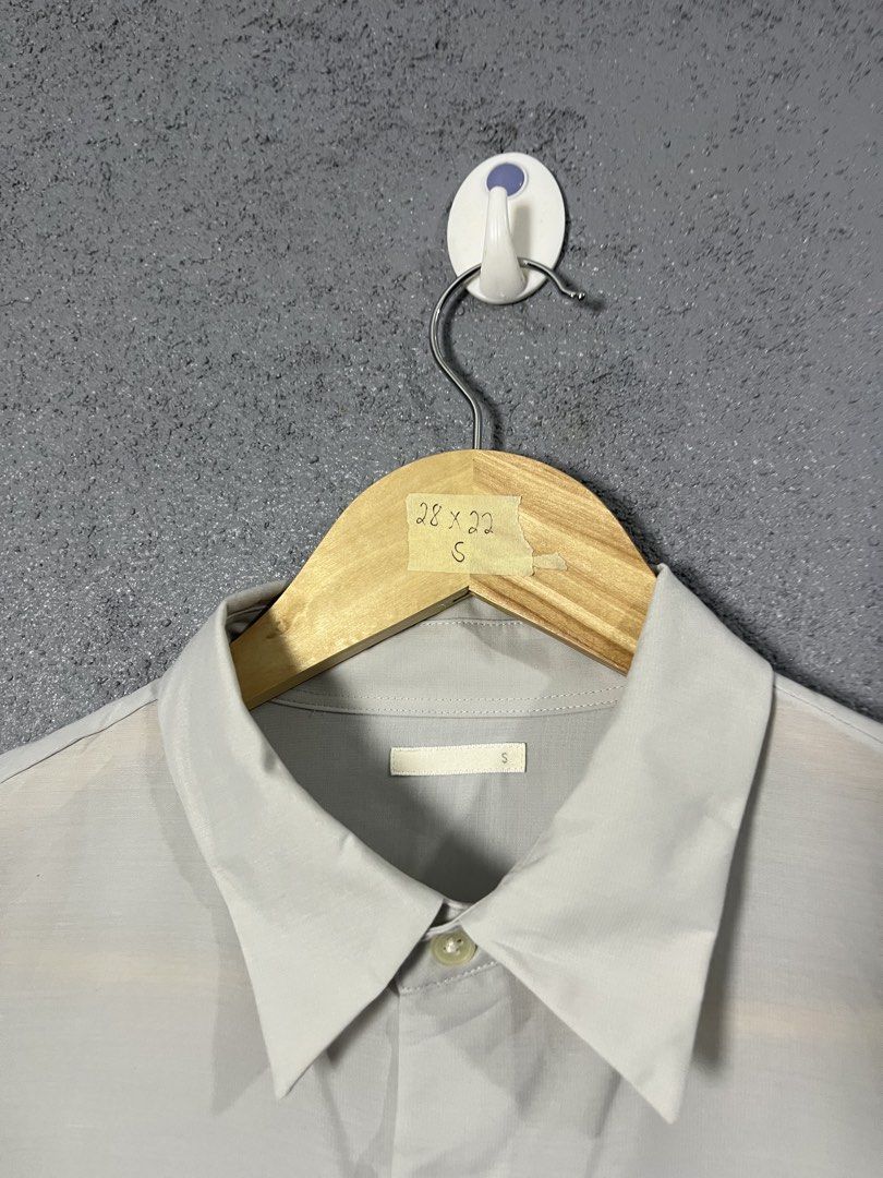 GU Light Grey Long Sleeve Button Down Shirt Size S (Category: Longsleeves) located in Famy. Submitted by basicthrifted (Listing ID 1464701764, Image 3). Description: - Brand/Model: GU Long Sleeve Button Down Shirt - Color: Light Grey - Size: Small (S) - Material: 100% polyester with recycled polyester blend (lightweight) - Features: Standard collar, front button closure, buttoned cuffs, straight hem line - Style: Clean minimalist look, versatile 