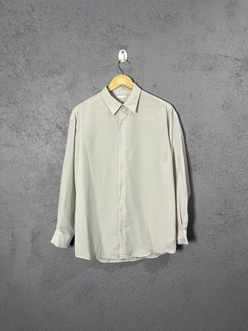 GU Light Grey Long Sleeve Button Down Shirt Size S (Category: Longsleeves) located in Famy. Submitted by basicthrifted (Listing ID 1464701764, Image 1). Description: - Brand/Model: GU Long Sleeve Button Down Shirt - Color: Light Grey - Size: Small (S) - Material: 100% polyester with recycled polyester blend (lightweight) - Features: Standard collar, front button closure, buttoned cuffs, straight hem line - Style: Clean minimalist look, versatile 