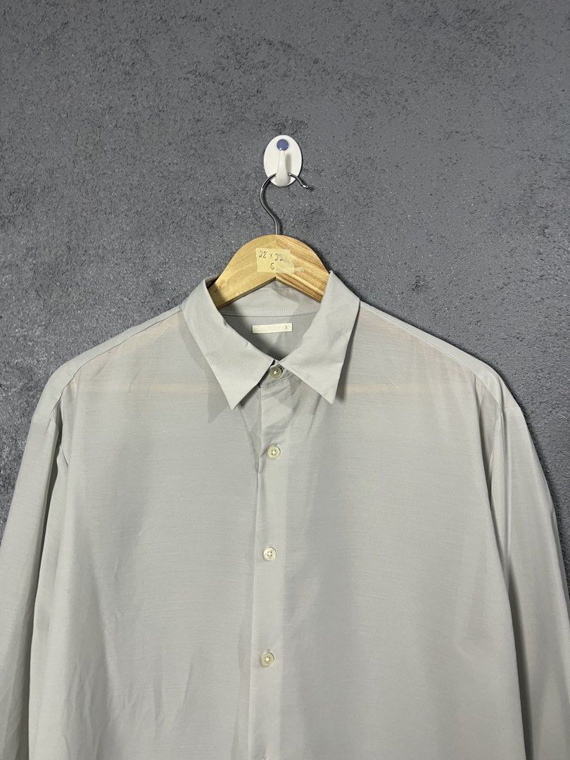 GU Light Grey Long Sleeve Button Down Shirt Size S (Category: Longsleeves) located in Famy. Submitted by basicthrifted (Listing ID 1464701764, Image 2). Description: - Brand/Model: GU Long Sleeve Button Down Shirt - Color: Light Grey - Size: Small (S) - Material: 100% polyester with recycled polyester blend (lightweight) - Features: Standard collar, front button closure, buttoned cuffs, straight hem line - Style: Clean minimalist look, versatile 