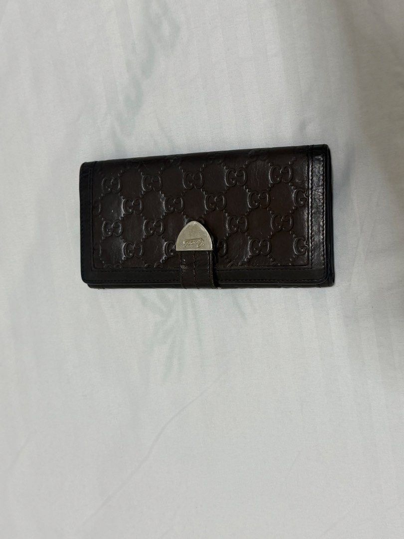 Gucci Brown Monogram Leather Long Wallet (Category: Everything Else Others) located in Santa Rosa. Submitted by decluttering_. (Listing ID 1464612494, Image 1). Description: - Authentic Brown Gucci Long Wallet - Classic GG Monogram Pattern - Secure Silver Clasp Closure - Ample Card Slots and Compartments - Made in Italy - Timeless and Essential Accessory.
