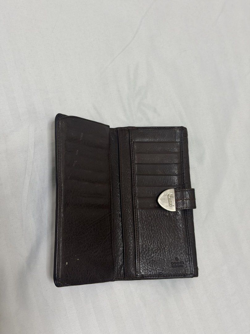 Gucci Brown Monogram Leather Long Wallet (Category: Everything Else Others) located in Santa Rosa. Submitted by decluttering_. (Listing ID 1464612494, Image 3). Description: - Authentic Brown Gucci Long Wallet - Classic GG Monogram Pattern - Secure Silver Clasp Closure - Ample Card Slots and Compartments - Made in Italy - Timeless and Essential Accessory.
