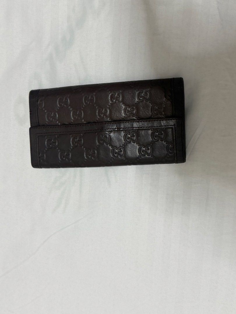 Gucci Brown Monogram Leather Long Wallet (Category: Everything Else Others) located in Santa Rosa. Submitted by decluttering_. (Listing ID 1464612494, Image 2). Description: - Authentic Brown Gucci Long Wallet - Classic GG Monogram Pattern - Secure Silver Clasp Closure - Ample Card Slots and Compartments - Made in Italy - Timeless and Essential Accessory.