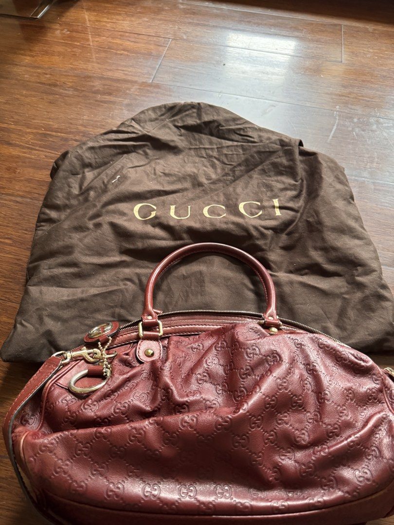Gucci Embossed Leather Handbag with Dust Bag (Category: Luxury Bags & Wallets) located in Quezon City. Submitted by wilstockpile (Listing ID 1464579707, Image 2). Description: - Authentic Gucci handbag - Deep red color - Signature GG embossed pattern - Lined interior with zippered pocket - Includes original Gucci dust bag - Perfect for everyday or special occasions.