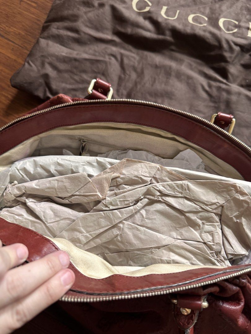 Gucci Embossed Leather Handbag with Dust Bag (Category: Luxury Bags & Wallets) located in Quezon City. Submitted by wilstockpile (Listing ID 1464579707, Image 3). Description: - Authentic Gucci handbag - Deep red color - Signature GG embossed pattern - Lined interior with zippered pocket - Includes original Gucci dust bag - Perfect for everyday or special occasions.