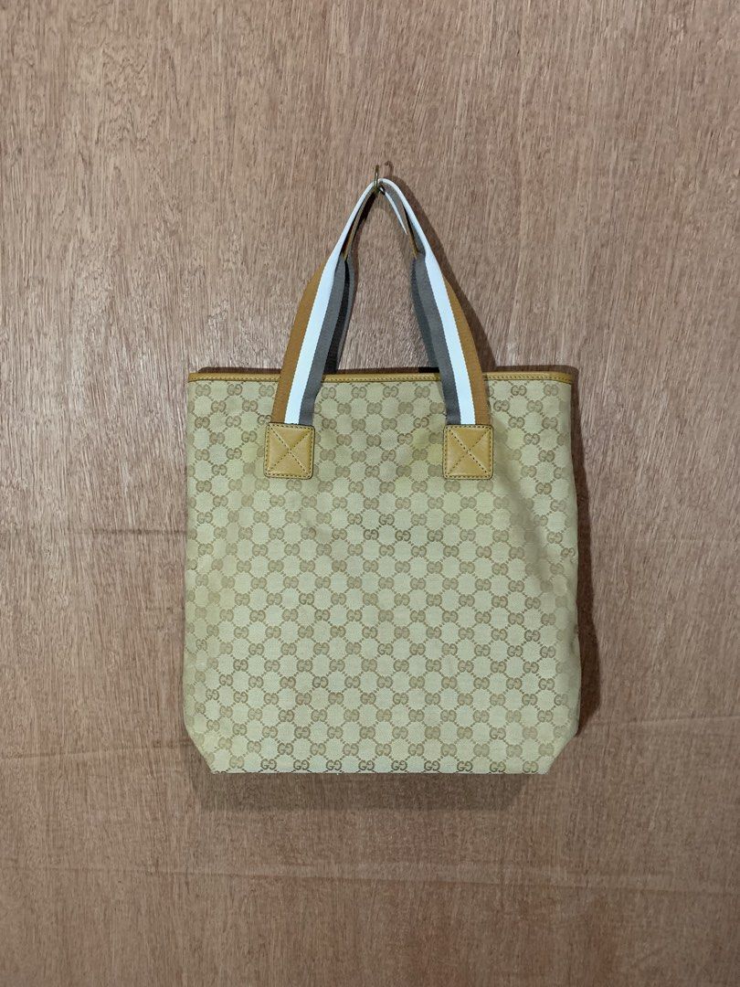 Gucci GG Monogram Canvas Tote Bag (Category: Luxury Bags & Wallets) located in Tacurong. Submitted by ljsthrift (Listing ID 1464580632, Image 3). Description: - Gucci two way bag - Beige GG monogram canvas with tan leather trim - Iconic Gucci logo plaque - Straps with stripe detail - Versatile: can be worn as a shoulder bag or tote - Ideal for everyday use.