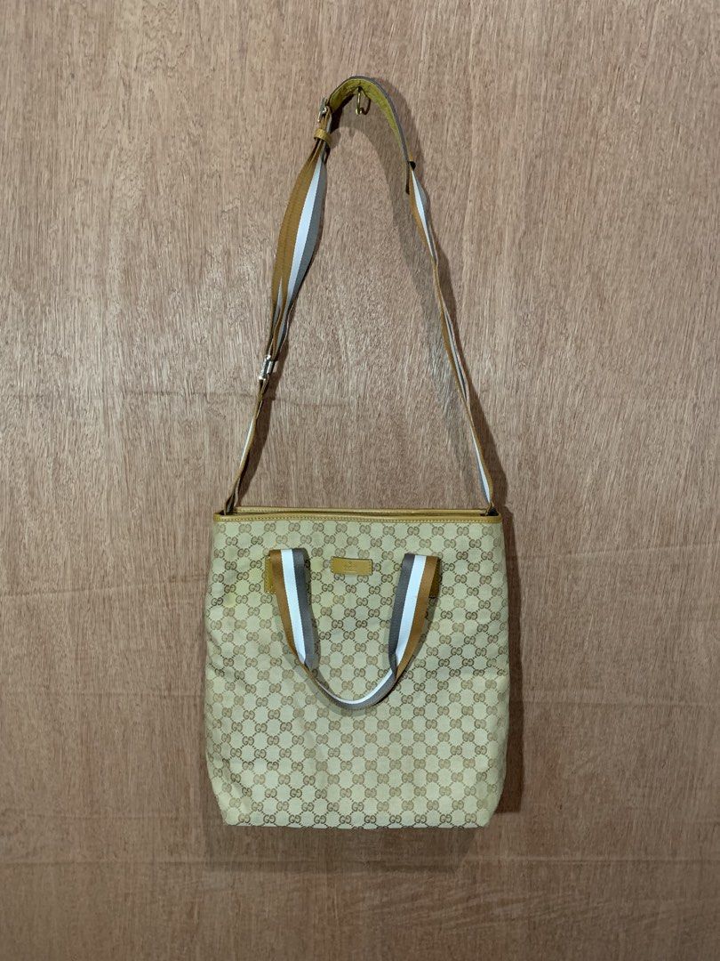Gucci GG Monogram Canvas Tote Bag (Category: Luxury Bags & Wallets) located in Tacurong. Submitted by ljsthrift (Listing ID 1464580632, Image 2). Description: - Gucci two way bag - Beige GG monogram canvas with tan leather trim - Iconic Gucci logo plaque - Straps with stripe detail - Versatile: can be worn as a shoulder bag or tote - Ideal for everyday use.