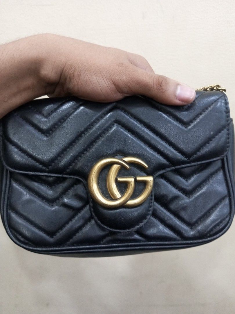 Gucci Marmont Small Shoulder Bag Black Leather (Category: Luxury Bags & Wallets) located in Bacolod City. Submitted by exequelgra46775 (Listing ID 1464649455, Image 2). Description: - Gucci Marmont Bag - Color: Black - Material: Quilted Leather - Hardware: Gold GG Logo and Chain Strap - Origin: Made in Italy - Serial Numbers: 476433 167732 and 264397 - Versatile: Ideal for nights out or everyday use.