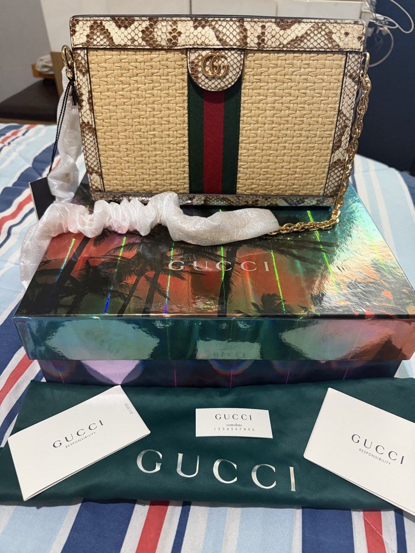 GUCCI RAFFIA ELAHPHE GG OPHIDIA (Category: Shoulder Bags) located in Taguig. Submitted by Zyannah (Listing ID 1464614632, Image 1). Description: GUCCI RAFFIA ELAHPHE GG OPHIDIA CHAIN SHOULDER BAG Brand new / UNUSED 💯 • Woven raffia body • Textured Elaphe (snake leather) trim • Signature green & red Web stripe • Classic GG motif • Elegant gold-tone hardware • Stylish chain shoulder strap • Complete inclusions • No flaws — unused Perfect statement