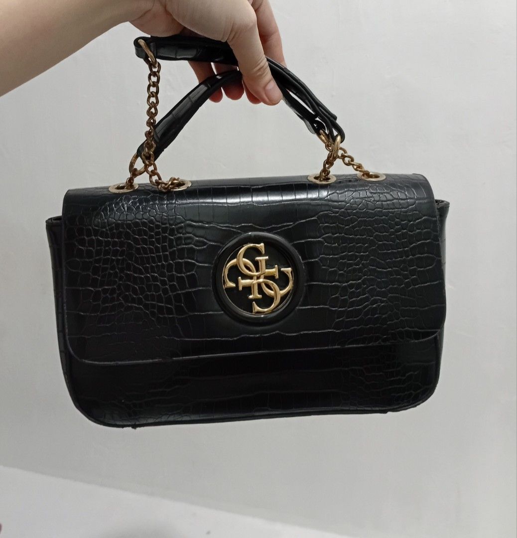 Guess Black Croc-Embossed Handbag with Gold Hardware (Category: Luxury Bags & Wallets) located in Manila. Submitted by kieerrrand52852 (Listing ID 1464709605, Image 1). Description: PreOwned Lightly Used Authentic Guess Croc Skin Leather Shoulder bag black Small - Color: Classic Black with a luxurious croc-embossed texture - Hardware: Elegant gold-toned details and chain strap - Closure: Flap closure featuring the iconic circular Guess logo - Sto