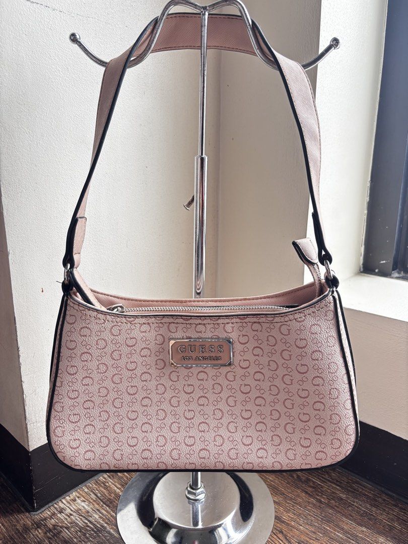 GUESS Los Angeles Monogram Shoulder Bag (Category: Shoulder Bags) located in Manila. Submitted by fiercewater-8107 (Listing ID 1464593296, Image 1). Description: - NEGOTIABLE - Cute pink Guess shoulder bag - All-over G logo pattern - Silver hardware with Guess Los Angeles plaque - Zipper closure - Perfect size for essentials - Great for everyday use.