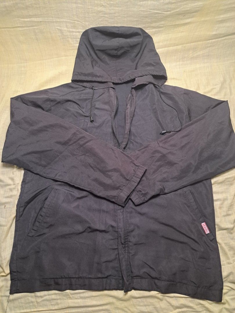Hanes Lightweight Hooded Jacket (Category: Coats, Jackets and Outerwear) located in Manila. Submitted by sainty.exe (Listing ID 1464619429, Image 3). Description: - Dark grey Hanes jacket - Zipper front closure - Two front pockets - Lightweight material, ideal for layering or mild weather - Easy to pack and carry - Material is similar to windbreaker (waterproof).
