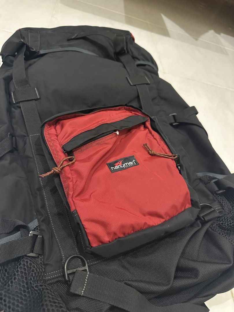 Hanuman Black Hiking Backpack 60L (Category: Backpacks) located in Baguio. Submitted by surplusbaguio.shop (Listing ID 1464622971, Image 3). Description: - Durable black hiking backpack - Eye-catching red front pocket - Multiple straps and buckles for secure gear attachment - Convenient side mesh pockets for water bottles or quick access items - Ample interior space for all your essentials - Ideal for camping, trekking, or travel - Ready for your