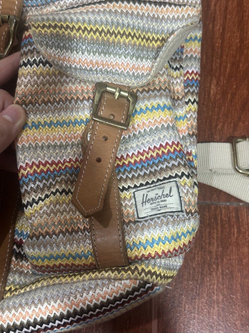 Herschel Supply Co. Backpack - Striped Pattern (Category: Backpacks) located in Paranaque City. Submitted by thriftclothing101 (Listing ID 1464599923, Image 2). Description: - Herschel backpack with a vibrant, colorful striped pattern. - Features stylish leather accents and secure buckle closures on the front pockets. - Adjustable straps for a comfortable fit. - Ample interior space, ideal for everyday essentials or travel. - Durable and versatil