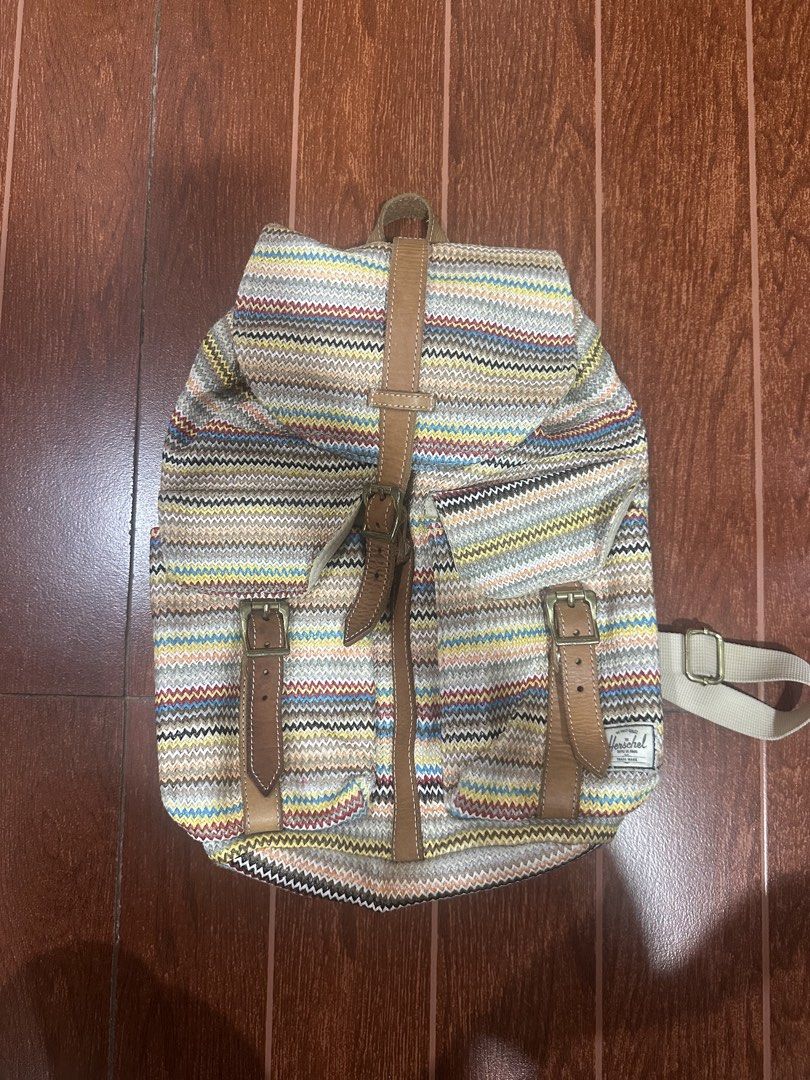 Herschel Supply Co. Backpack - Striped Pattern (Category: Backpacks) located in Paranaque City. Submitted by thriftclothing101 (Listing ID 1464599923, Image 1). Description: - Herschel backpack with a vibrant, colorful striped pattern. - Features stylish leather accents and secure buckle closures on the front pockets. - Adjustable straps for a comfortable fit. - Ample interior space, ideal for everyday essentials or travel. - Durable and versatil