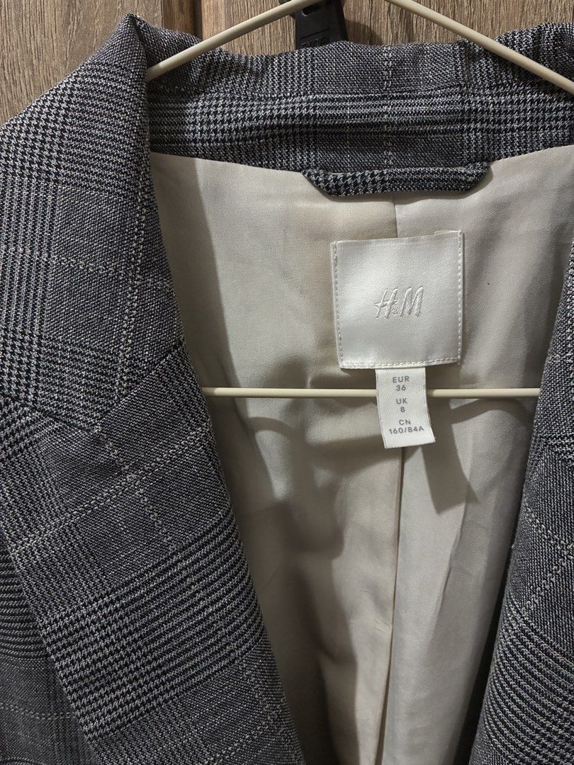H&M Grey Plaid Double-Breasted Blazer (Category: Coats, Jackets and Outerwear) located in Makati City. Submitted by kmc01 (Listing ID 1464674797, Image 2). Description: - Grey plaid blazer from H&M - Classic double-breasted design - Two-button closure - Light neutral colored lining - Versatile for work or evening wear - Easy to pair with various outfits - Refer to label for sizing.