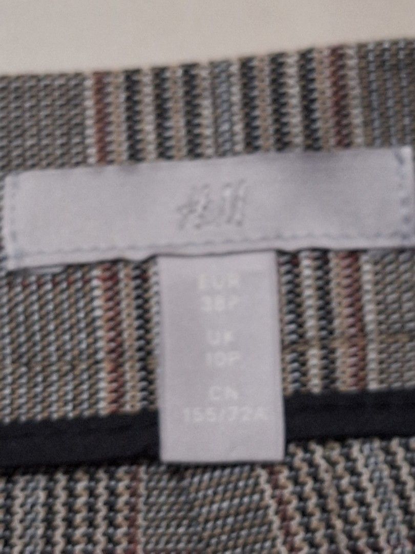 H&M Plaid Button Front Pencil Skirt with slit (Category: Skirts) located in Makati City. Submitted by worn2work_treasures (Listing ID 1464618067, Image 3). Description: - Grey plaid pencil skirt - Brand: H&M - Features button front detail - Knee length - Perfect for work or casual outings - Can be dressed up or down Length from waist - 21.5 inches or 55.5 cm Hips - 18 inches Composition: Polyester, Viscose, Elastin .