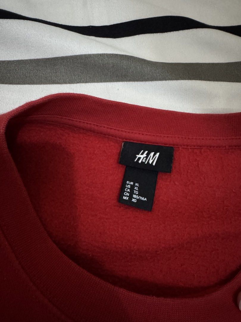 H&M Red Bull Terrier Graphic Sweatshirt (Category: Coats, Jackets and Outerwear) located in Bulacan. Submitted by alshopie (Listing ID 1464608207, Image 2). Description: - Red H&M sweatshirt - Features a striking bull terrier head graphic - Long sleeves with ribbed cuffs and hem - Cozy fleece lining inside for extra warmth - Ideal for everyday casual wear.