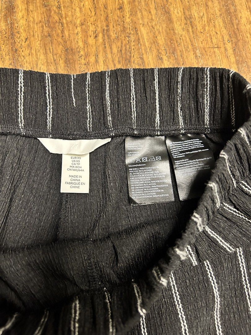 H&M Striped Wide-Leg Trousers (Category: Other Bottoms) located in Antipolo. Submitted by tshopph (Listing ID 1464650134, Image 3). Description: H&M Black Striped Wide-Leg Pants / Trousers Upgrade your m wardrobe with these stylish, lightweight wide-leg trousers. Features a high-rise waistband for all-day comfort and a flattering, flowy wide-leg silhouette. Made with a soft, textured crinkle/plissé-style fabric that drapes effortlessly. Condition