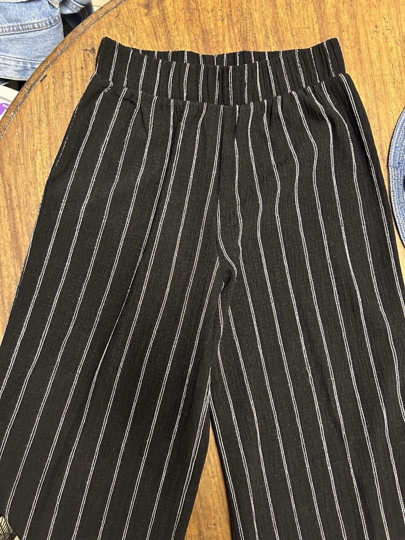 H&M Striped Wide-Leg Trousers (Category: Other Bottoms) located in Antipolo. Submitted by tshopph (Listing ID 1464650134, Image 2). Description: H&M Black Striped Wide-Leg Pants / Trousers Upgrade your m wardrobe with these stylish, lightweight wide-leg trousers. Features a high-rise waistband for all-day comfort and a flattering, flowy wide-leg silhouette. Made with a soft, textured crinkle/plissé-style fabric that drapes effortlessly. Condition