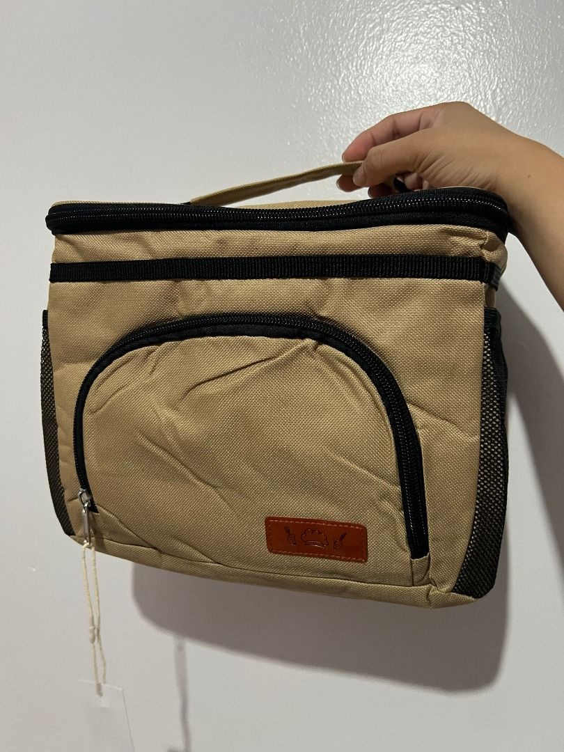 HOTOR Insulated Lunch Cooler Bag Beige (Category: Tote Bags) located in Davao. Submitted by jpnusapasabuyfindsdvo (Listing ID 1464699624, Image 2). Description: - Brand: HOTOR (tag still attached) - Color: Neutral khaki beige - Condition: Brand new - Features: Insulated main compartment with double zipper, front zippered pocket, and dual mesh side pockets - Portability: Sturdy top handle for easy carrying - Versatile: Great for work, school, or p