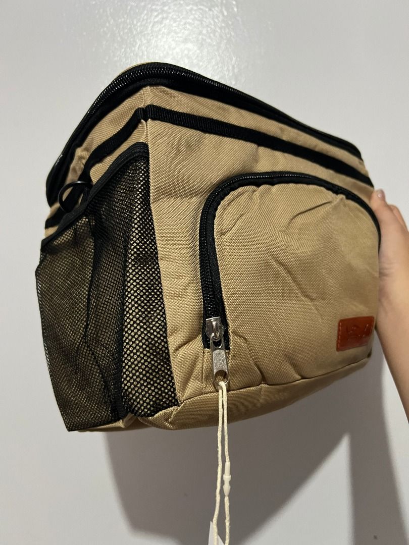 HOTOR Insulated Lunch Cooler Bag Beige (Category: Tote Bags) located in Davao. Submitted by jpnusapasabuyfindsdvo (Listing ID 1464699624, Image 3). Description: - Brand: HOTOR (tag still attached) - Color: Neutral khaki beige - Condition: Brand new - Features: Insulated main compartment with double zipper, front zippered pocket, and dual mesh side pockets - Portability: Sturdy top handle for easy carrying - Versatile: Great for work, school, or p