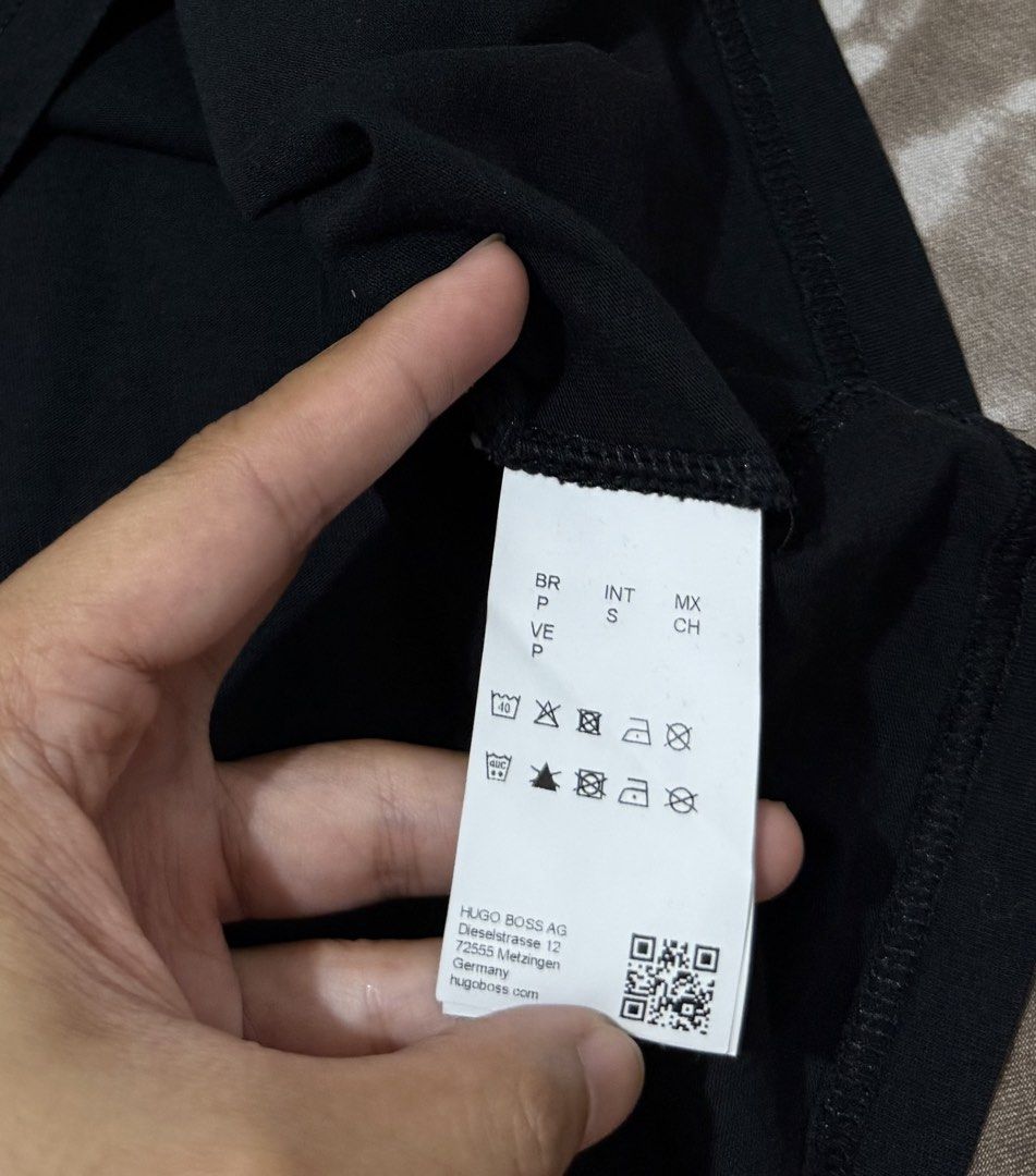 Hugo Boss Black big logo (Category: Tshirts & Polo Shirts ) located in Manila. Submitted by calvinomateo14 (Listing ID 1464734140, Image 3). Description: - Brand: Hugo Boss - Color: Black - Size: S (Regular Fit) - Material: Responsibly sourced cotton with built-in sun protection - Design: Large textured BOSS logo on chest with smaller text underneath - Authenticity: Inner collar tag and side care label with QR code intact - Condition: Clean and c