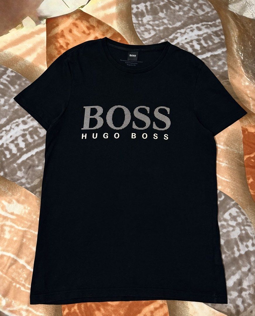Hugo Boss Black big logo (Category: Tshirts & Polo Shirts ) located in Manila. Submitted by calvinomateo14 (Listing ID 1464734140, Image 1). Description: - Brand: Hugo Boss - Color: Black - Size: S (Regular Fit) - Material: Responsibly sourced cotton with built-in sun protection - Design: Large textured BOSS logo on chest with smaller text underneath - Authenticity: Inner collar tag and side care label with QR code intact - Condition: Clean and c