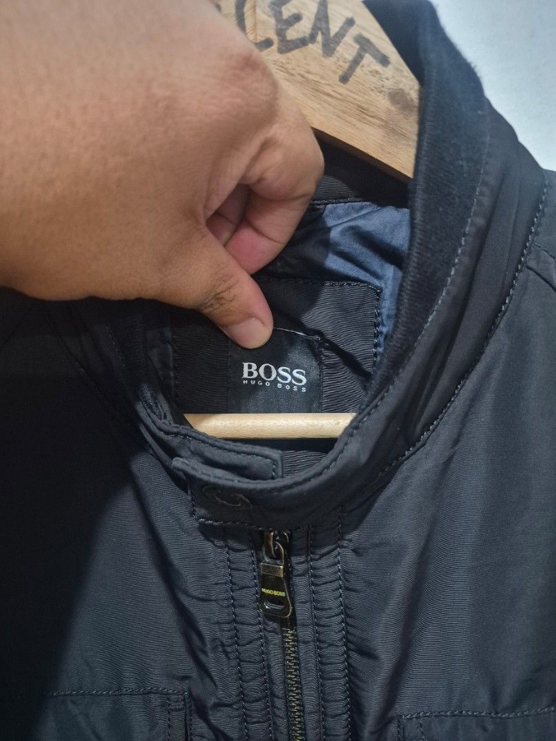 Hugo Boss Black Winter Jacket Outerwear (Category: Coats, Jackets and Outerwear) located in Bulacan. Submitted by vince4593 (Listing ID 1464712829, Image 2). Description: - Authentic Hugo Boss black winter jacket - Heavyweight and very warm construction - Full front zipper with branded metal hardware and snap buttons - Multiple front utility pockets with flap closures and zippers - Stylish high collar design - Padded quilted dark blue interior li