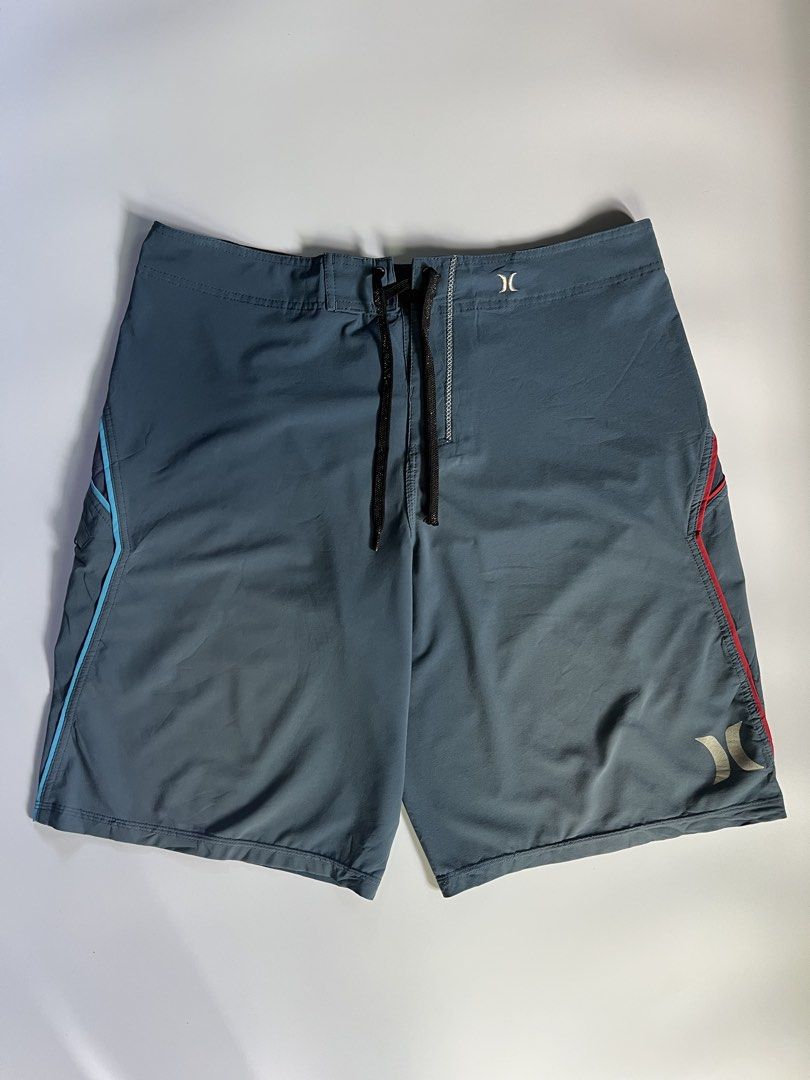 Hurley Phantom Board Shorts Swim Trunks (Category: Swim Trunks & Board Shorts) located in Baler. Submitted by allthrifted31 (Listing ID 1464732102, Image 1). Description: - Brand: Hurley Phantom - Color: Dark grey with blue and reddish-orange gradient panels - Fabric: Performance stretch, lightweight, and quick-drying - Features: Secure zippered side pocket with logo, adjustable drawstring waist - Condition: Excellent for surfing, swimming, and b