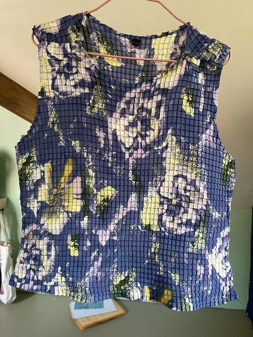 issey miyake vibes (Category: Sleeveless) located in Baybay. Submitted by shikita27906 (Listing ID 1464644902, Image 1). Description: - Funky pleated sleeveless top - Blue base with abstract floral print (yellow, purple, green) - Unique texture fits M-L.