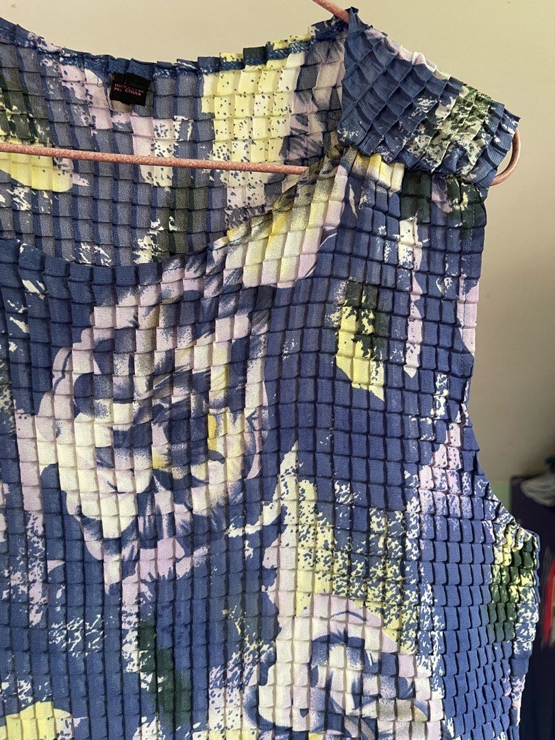 issey miyake vibes (Category: Sleeveless) located in Baybay. Submitted by shikita27906 (Listing ID 1464644902, Image 2). Description: - Funky pleated sleeveless top - Blue base with abstract floral print (yellow, purple, green) - Unique texture fits M-L.