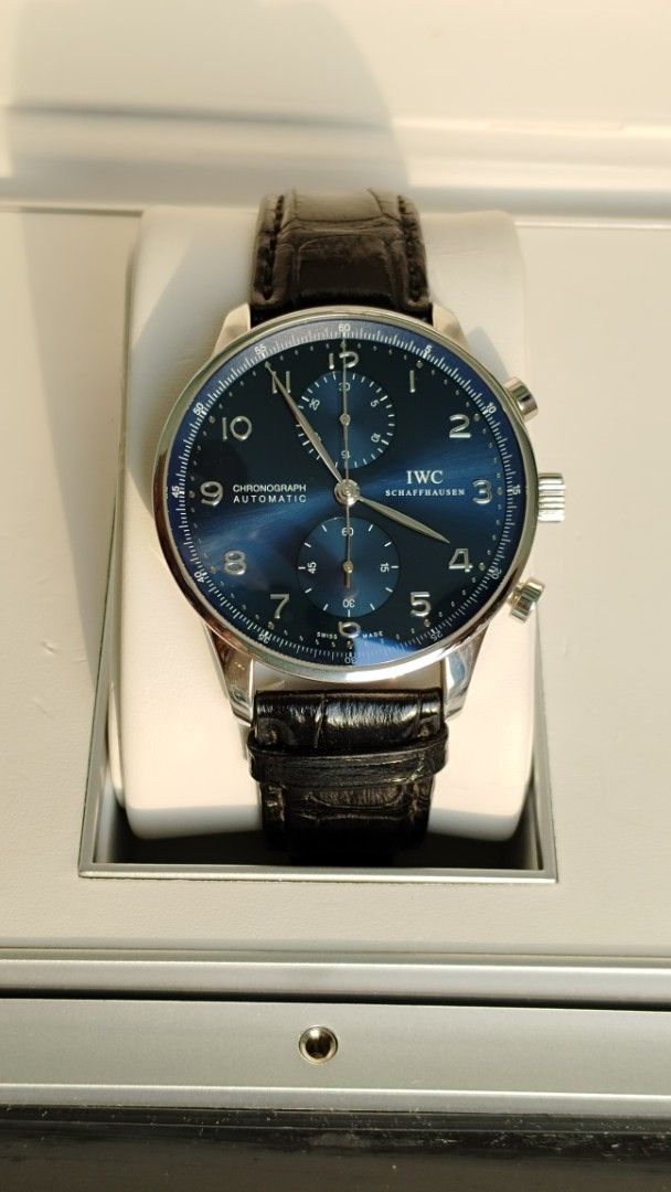 IWC PORTUGUESE (Category: Men's Watches) located in Manila. Submitted by epicmountain.05472a (Listing ID 1464718686, Image 1). Description: - Brand: IWC Schaffhausen Chronograph - Dial: Striking blue with silver Arabic numerals - Movement: Automatic - Case: Polished stainless steel - Strap: Black leather with IWC signed deployant clasp - Condition: Clean crystal and subdials - Style: Classic dress chronograph - Guaranteed authentic, rush shipping