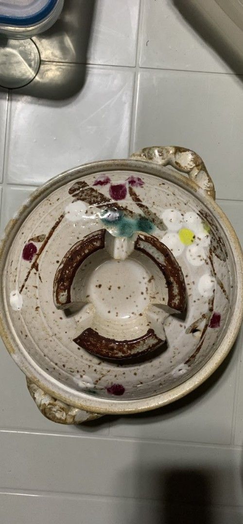 Japanese Ceramic Donabe Clay Pot with Vegetable Illustrations (Category: Cookware & Accessories) located in Manila. Submitted by kashklent0 (Listing ID 1464720739, Image 1). Description: - Hand-painted donabe clay pot with charming carrot, eggplant, and radish lid illustrations - Medium size, ideal for stews and cozy - hot pot nights at home - Double-handled design with a matching lid and steam vent hole - Bottom shows normal signs of previous st