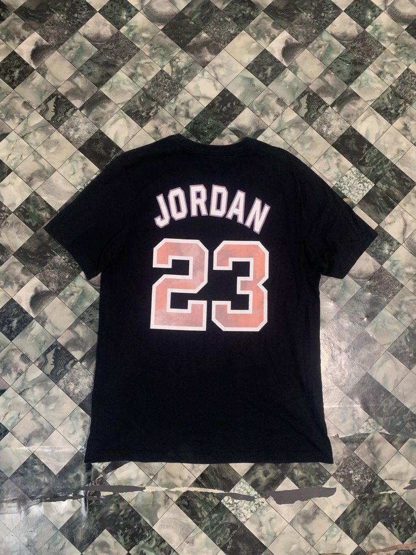Jordan Jumpman 23 Graphic Tee Black Size L (Category: Tshirts & Polo Shirts ) located in Cebu City. Submitted by tangubrhia45277 (Listing ID 1464701127, Image 2). Description: - Brand: Jordan - Color: Black with pinkish-orange logo - Size: Large - Material: 100% Cotton - Fit: Standard short sleeve crewneck - Design: Large Jumpman logo on front chest, large '23' and Jordan text on the upper back - Authenticity: Style code DO8899-010 on inner tag.