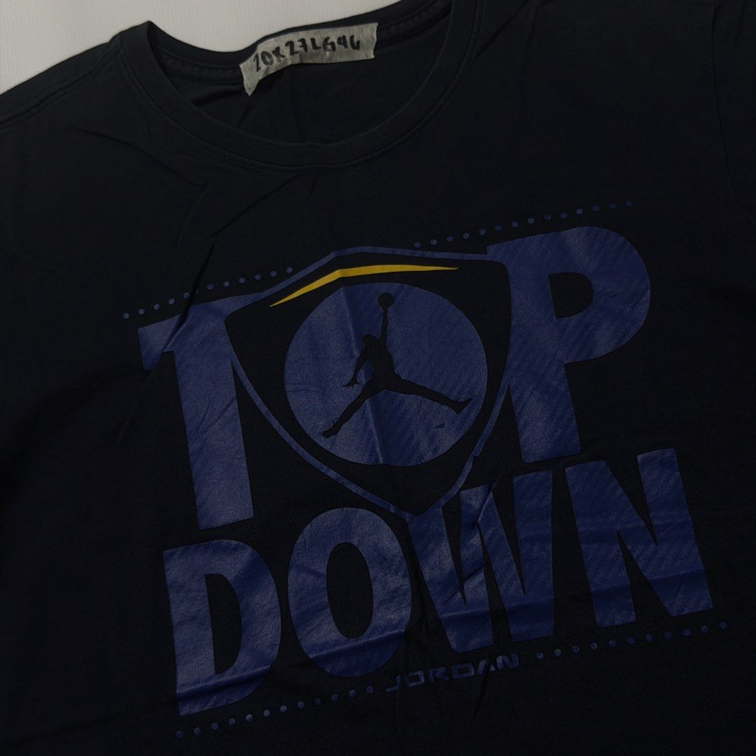 Jordan Top Down T-Shirt Black Size L (Category: Tshirts & Polo Shirts ) located in Manila. Submitted by johnedel_james (Listing ID 1464696776, Image 2). Description: - Authentic Jordan graphic t-shirt (Style code: 717883-010) - Color: Dark Navy / Black - Size: Large (Regular fit) - Material: 100% Cotton, Made in China - Design: Large 'TOP DOWN' front print with iconic Jumpman logo inside shield graphic - Condition: Crew neck, short sleeves, casua