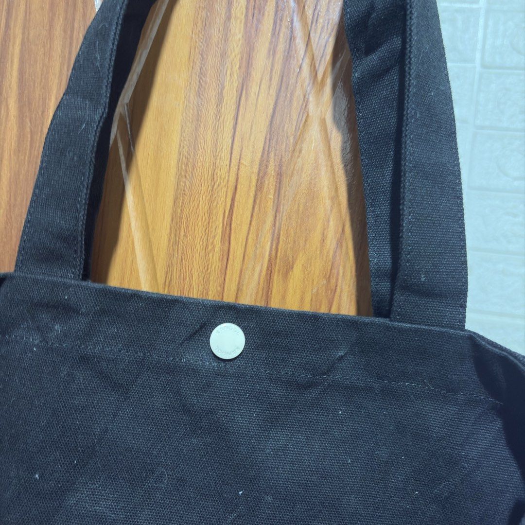 Kangol Black Canvas Tote Bag with Shoulder Strap (Category: Tote Bags) located in Carmen. Submitted by rr_thrifts (Listing ID 1464720150, Image 3). Description: - Authentic Kangol canvas tote bag in classic black - Heavy-duty, durable material ideal for daily use, school, or errands - Features a large white Kangol kangaroo logo and lettering on the front - Dual carry handles and a convenient adjustable shoulder strap included - Secure snap button