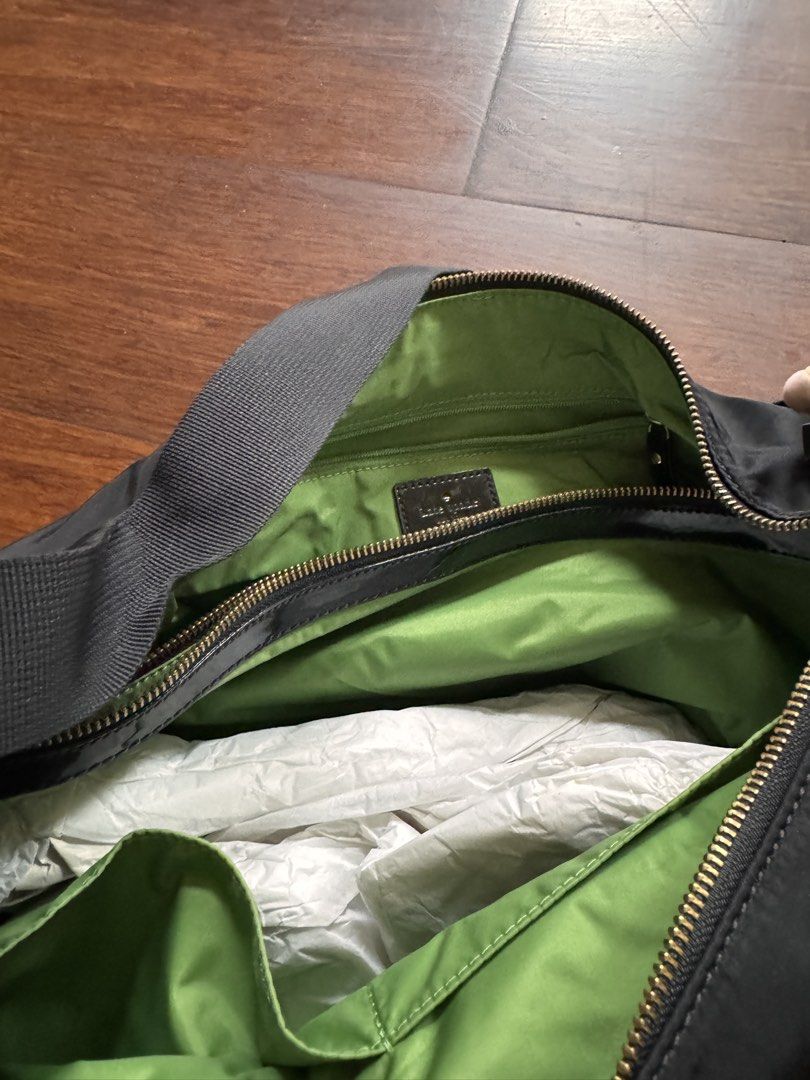 Kate Spade Black Nylon Diaper Bag with Green Interior (Category: Tote Bags) located in Quezon City. Submitted by wilstockpile (Listing ID 1464579804, Image 2). Description: - Brand: Kate Spade - Material: Black Nylon - Interior: Bright Green - Features: Multiple exterior pockets for easy access - Closure: Zip-top main compartment - Includes: Changing pad - Ideal for: Everyday use or travel.