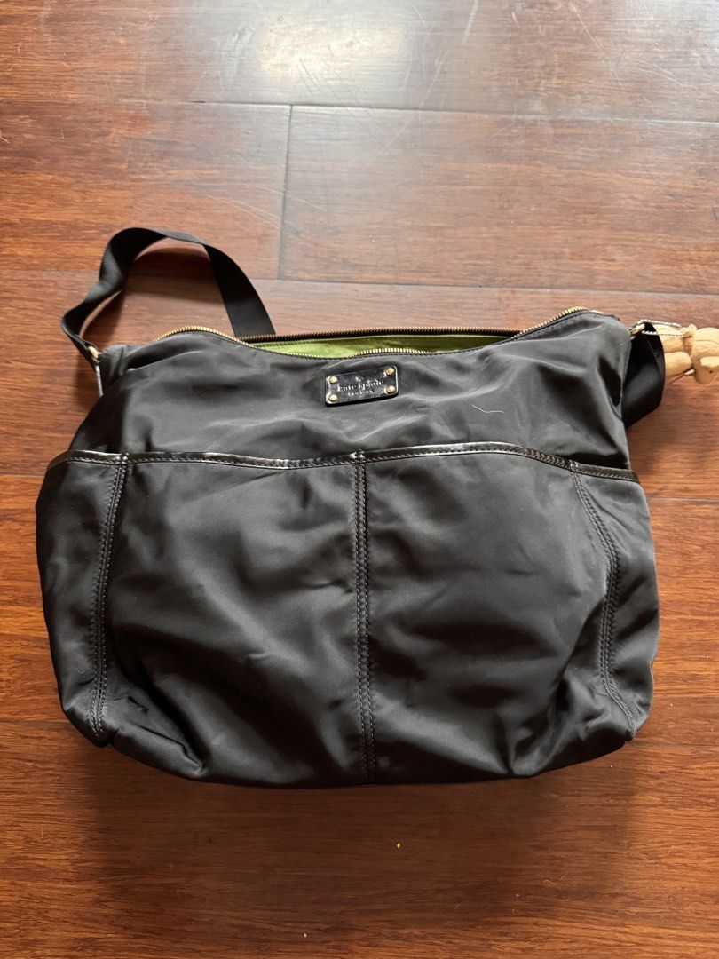Kate Spade Black Nylon Diaper Bag with Green Interior (Category: Tote Bags) located in Quezon City. Submitted by wilstockpile (Listing ID 1464579804, Image 1). Description: - Brand: Kate Spade - Material: Black Nylon - Interior: Bright Green - Features: Multiple exterior pockets for easy access - Closure: Zip-top main compartment - Includes: Changing pad - Ideal for: Everyday use or travel.
