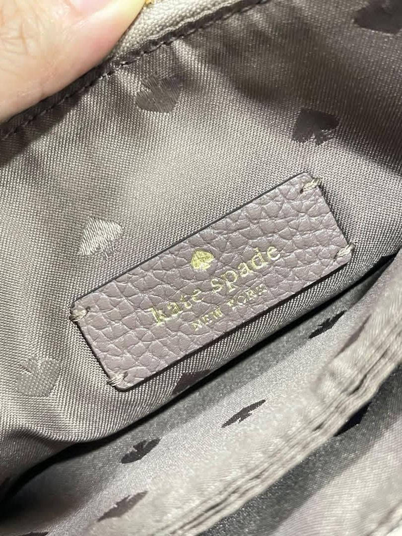 Kate Spade Gray (100% orig & Pre-loved) (Category: Cross-body Bags) located in Quezon City. Submitted by declutterbybd (Listing ID 1464684133, Image 3). Description: Authentic 💯 — Kate Spade Crossbody bag (Gray) *100% Authenticity Guaranteed! *Bag purchased directly from US *Design: Gray Crossbody bag. The strap has a snake print design. Many pockets inside. *Status: Used Bag but the bag still in good condition *Issue: The Embossed “K” in the fr