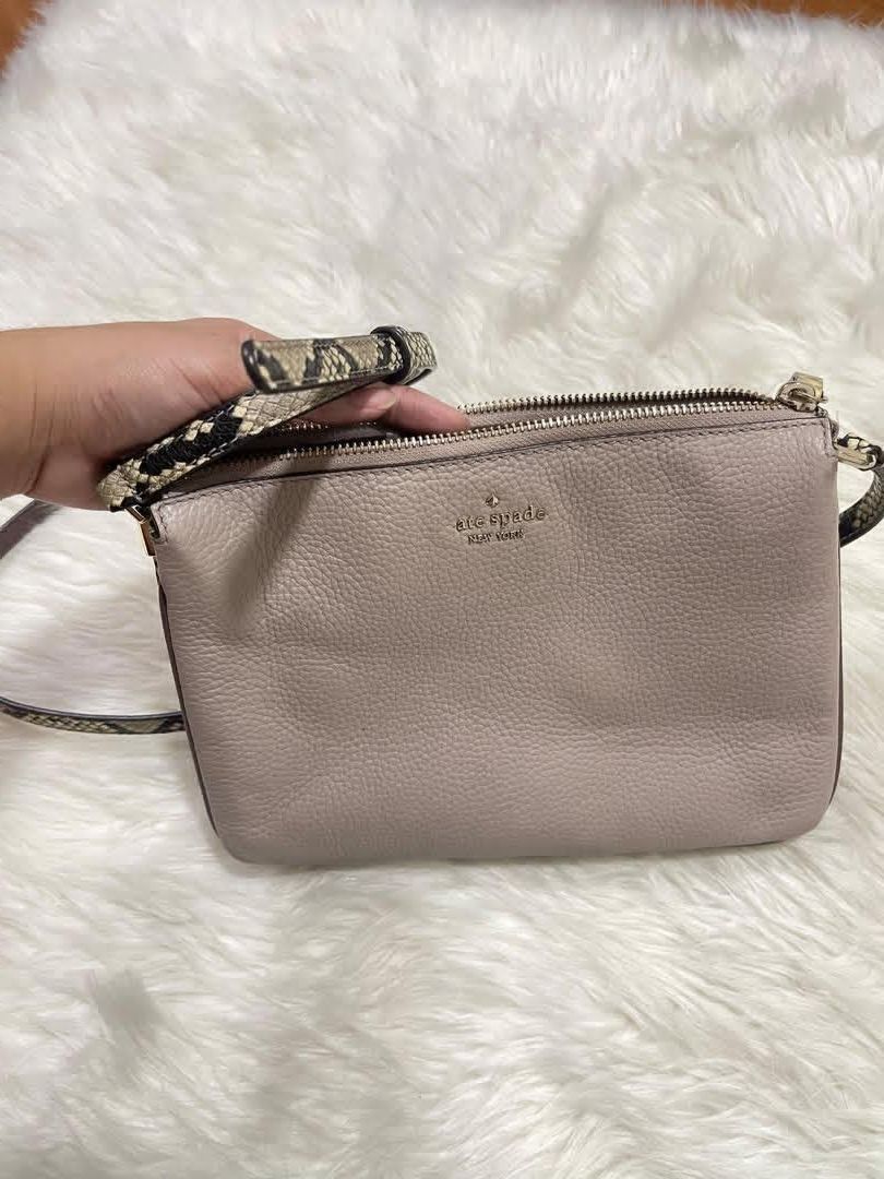 Kate Spade Gray (100% orig & Pre-loved) (Category: Cross-body Bags) located in Quezon City. Submitted by declutterbybd (Listing ID 1464684133, Image 2). Description: Authentic 💯 — Kate Spade Crossbody bag (Gray) *100% Authenticity Guaranteed! *Bag purchased directly from US *Design: Gray Crossbody bag. The strap has a snake print design. Many pockets inside. *Status: Used Bag but the bag still in good condition *Issue: The Embossed “K” in the fr