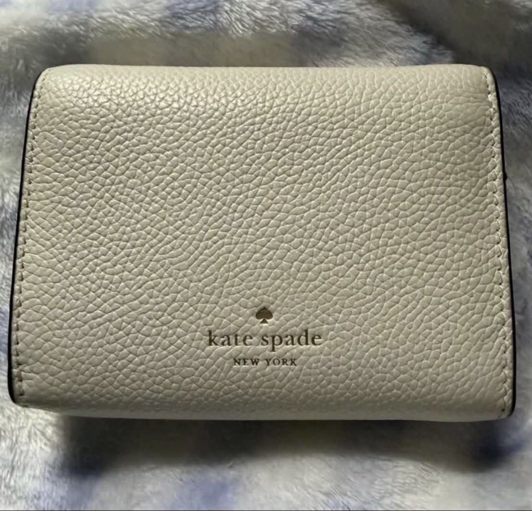 Kate Spade Kayla (Category: Wallets & Card holders) located in Las Pinas. Submitted by kaye_declutter37 (Listing ID 1464644480, Image 2). Description: Used Kate Spade in Kayla White 🚫No visible issues tear/Scratches i HardWares 💓FEATURES: Interior zip pocket, bill slot 6 interior credit card slots Flap with snap Interior zip compartment Metal Spade RFS: Declutter too much wallet ♥️ Not entertaining low ballers. .