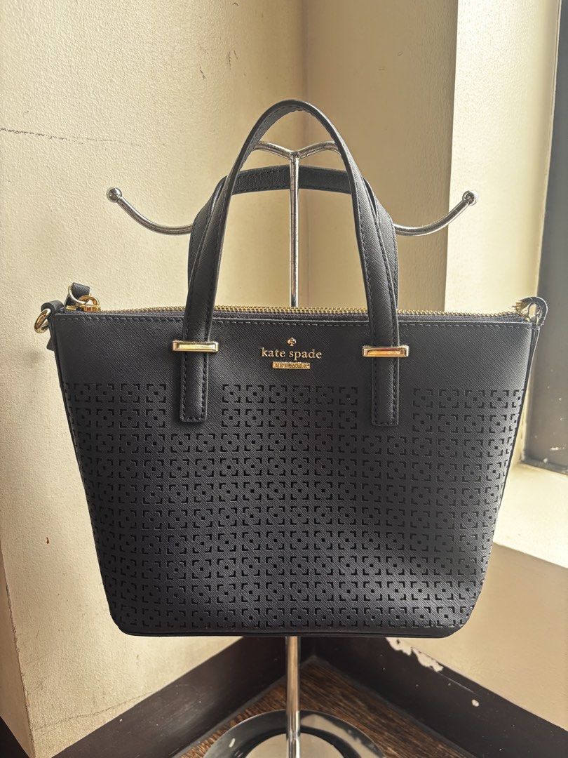 Kate Spade Navy Blue Tote Bag (Category: Tote Bags) located in Manila. Submitted by fiercewater-8107 (Listing ID 1464595181, Image 1). Description: - Authentic Kate Spade blue tote bag - Elegant perforated pattern on the front - Shiny gold hardware details - Secure zipper closure - Comfortable top handles for easy carrying - Ideal for everyday use - Interior and exterior are clean and well-maintained.