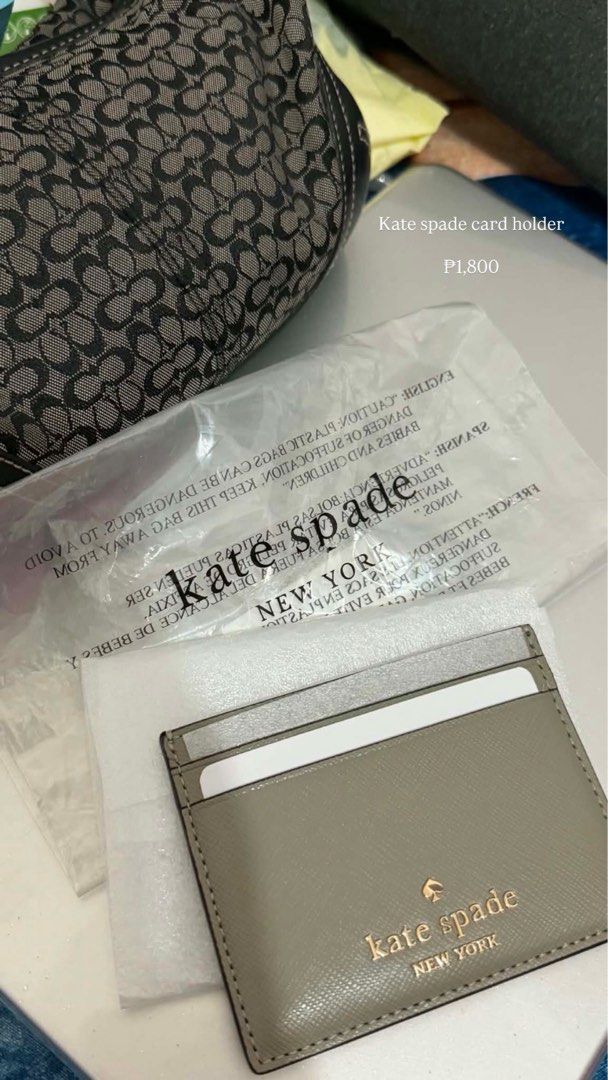 Kate Spade New York Card Holder (Category: Wallets & Card holders) located in Manila. Submitted by hoellyshit_444 (Listing ID 1464641085, Image 1). Description: - Authentic Kate Spade card holder - Chic neutral grey color with elegant gold lettering - Includes original packaging - Ample card slots for organization - Ideal for everyday essentials or travel convenience.
