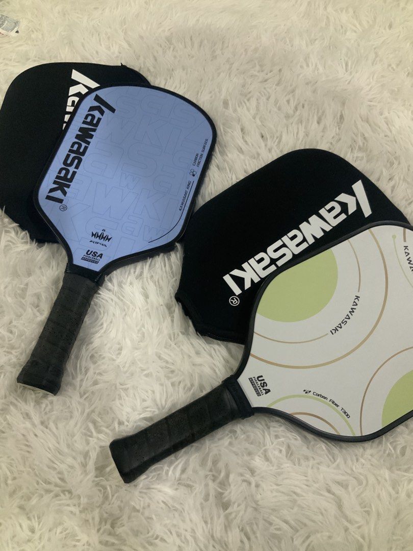 Kawasaki Pickleball Paddle Bundle (Category: Racket and Ball Sports) located in Manila. Submitted by beyondthespotlight (Listing ID 1464707226, Image 1). Description: Set of 2 Kawasaki pickleball paddles Paddle 1 (Blue and Green) : Carbon Fiber T300 w/ fiberglass Paddle 2 (Blue King) : Carbon Fiber, signs of usage on paddle - Both paddles feature carbon fiber construction for excellent playability - Includes 2 official kawasaki covers - Officiall