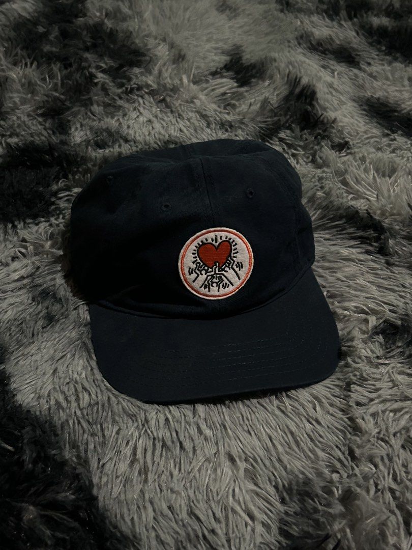 Keith Haring x Mad Engine Navy Blue Baseball Cap (Category: Caps & Hats) located in Cadiz. Submitted by jaybatiller (Listing ID 1464614944, Image 1). Description: - Navy blue baseball cap - Features a cool Keith Haring graphic patch on the front - Adjustable strap at the back for a good fit - Made from 100% cotton - One size fits most - Great for everyday wear.