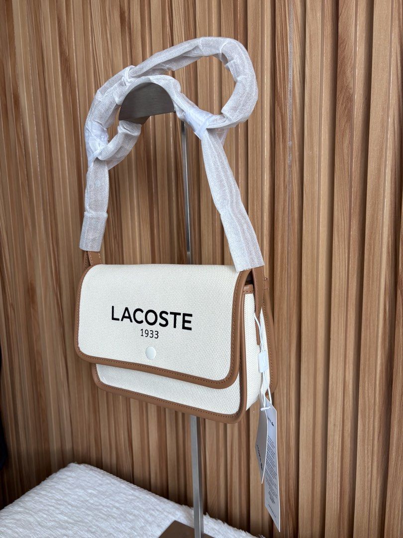 LACOSTE FLAP CROSSOVER BAG IN NATURAL TAN (Category: Cross-body Bags) located in Imus. Submitted by dumpitlikeaqueen (Listing ID 1464712333, Image 3). Description: • Store-bought at Lacoste, Duty Free Fiestamall • With tags, plastic & paper bag • Original Price: 145USD • 2 pcs. on hand • Open for layaway • Instagram Shop: @dumpitlikeaqueen.