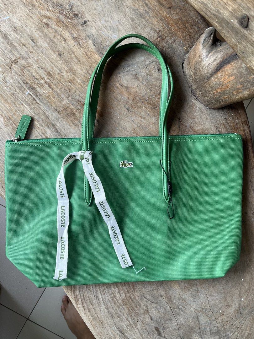 Lacoste Green Tote Bag (Category: Tote Bags) located in Siniloan. Submitted by marceiron316276 (Listing ID 1464628971, Image 1). Description: - Authentic green Lacoste tote bag - Iconic crocodile logo detail - Convenient front zipper pocket - Stylish ribbon accent - Spacious enough for everyday use - Clean and minimalist design.