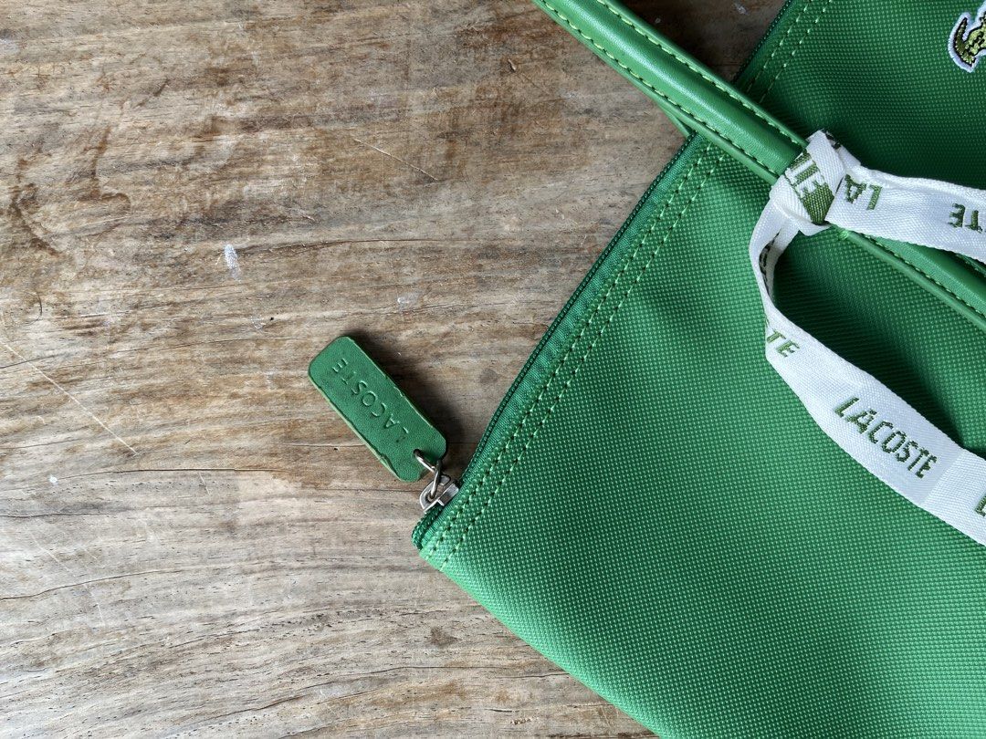 Lacoste Green Tote Bag (Category: Tote Bags) located in Siniloan. Submitted by marceiron316276 (Listing ID 1464628971, Image 3). Description: - Authentic green Lacoste tote bag - Iconic crocodile logo detail - Convenient front zipper pocket - Stylish ribbon accent - Spacious enough for everyday use - Clean and minimalist design.
