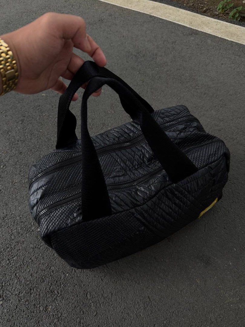 Lacoste Quilted Croc Duffel Bag (Category: Sling Bags) located in Manila. Submitted by s2pdon. (Listing ID 1464599217, Image 2). Description: - Brand: Lacoste - Color: Black - Material: Quilted fabric - Design: Unique geometric pattern all over - Compartments: Two main zippered sections - Interior: Bright yellow lining - Ideal for: Gym, weekend getaways - Size: Approximately 16 inches long - Authentic!.